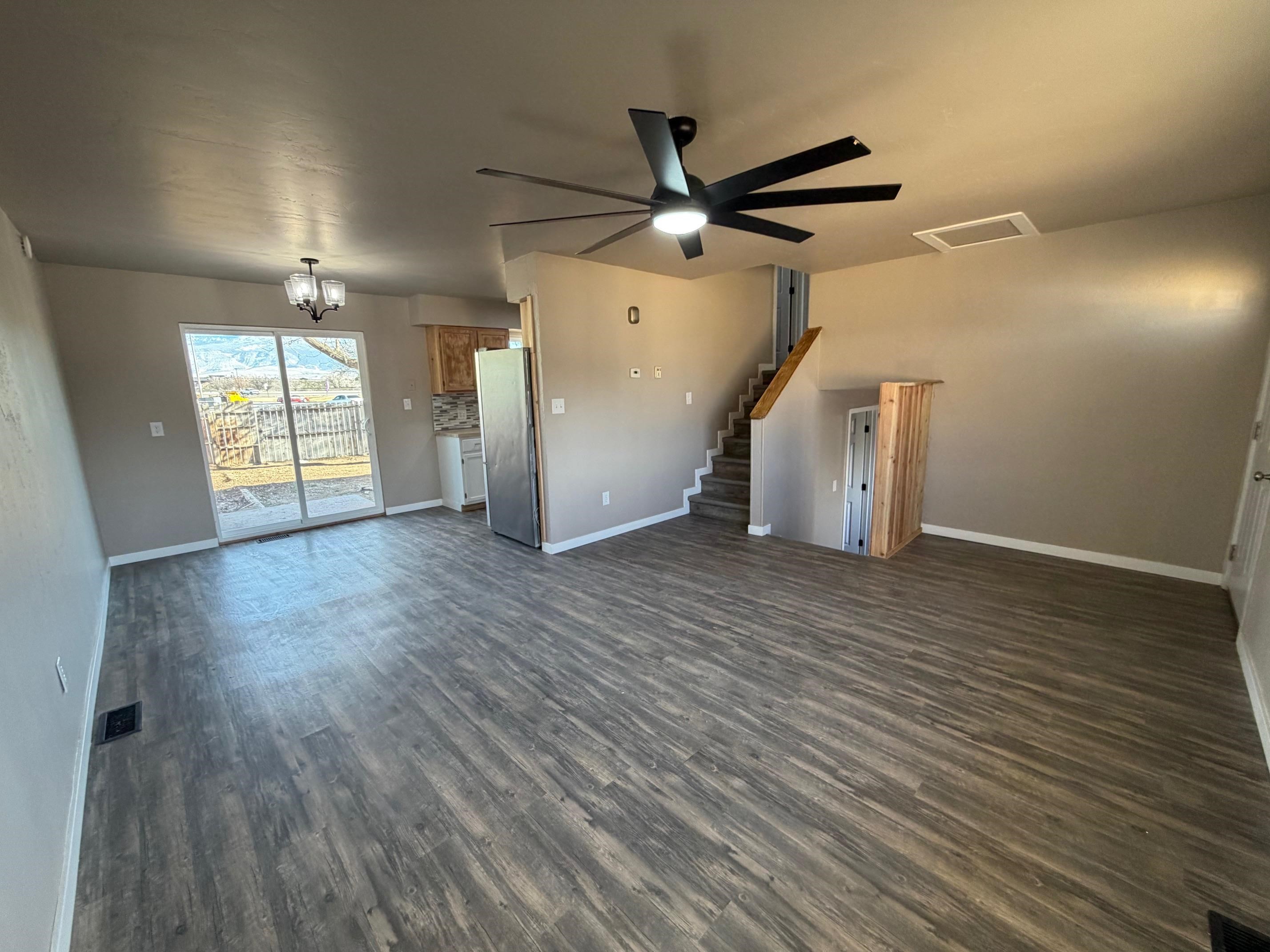 558 1/2 31 3/4 Road Grand Junction, CO 81504 - Photo 3 of 25 an empty room with wooden floor fan and windows