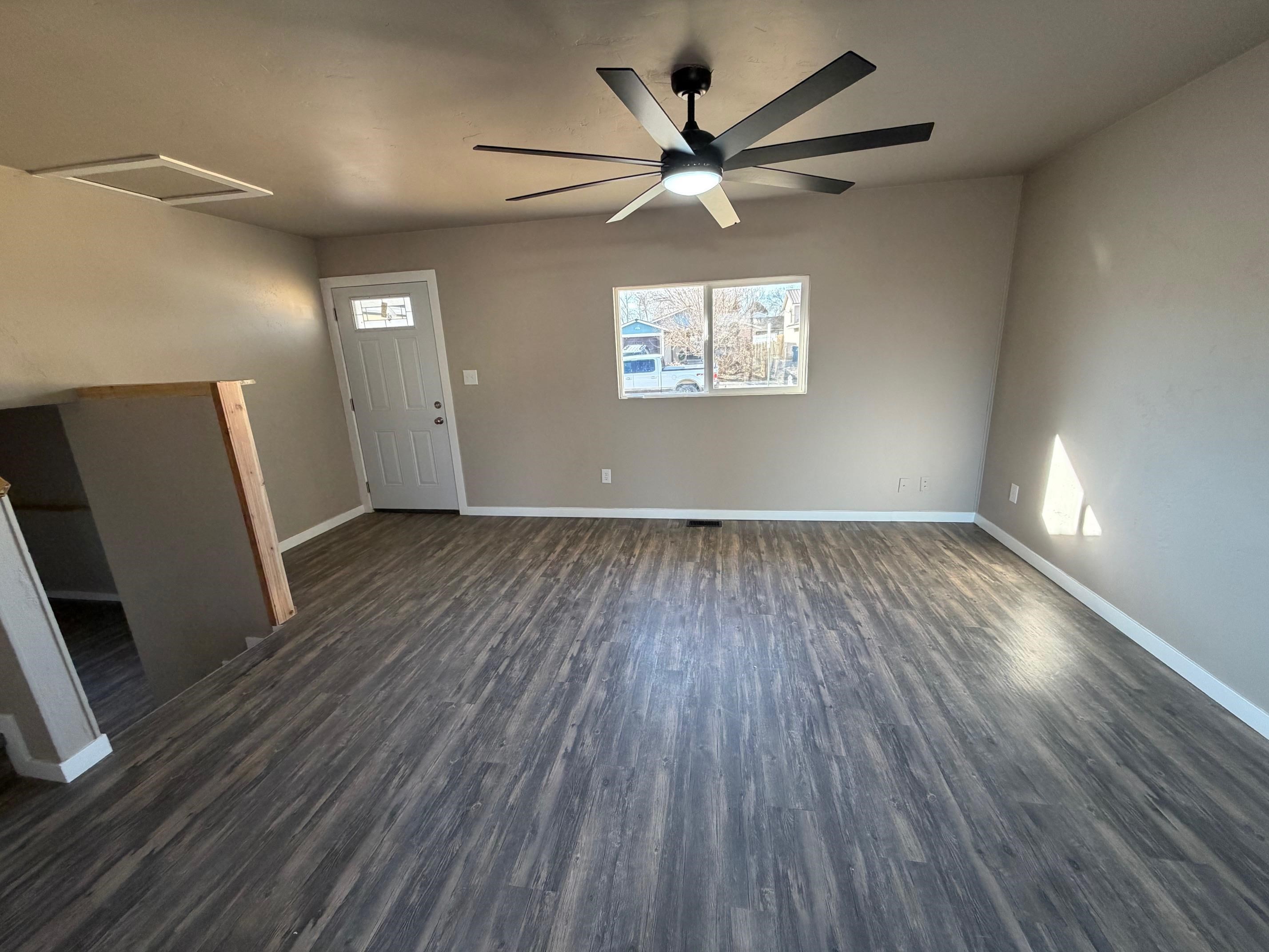 558 1/2 31 3/4 Road Grand Junction, CO 81504 - Photo 4 of 25 an empty room with wooden floor fan and windows