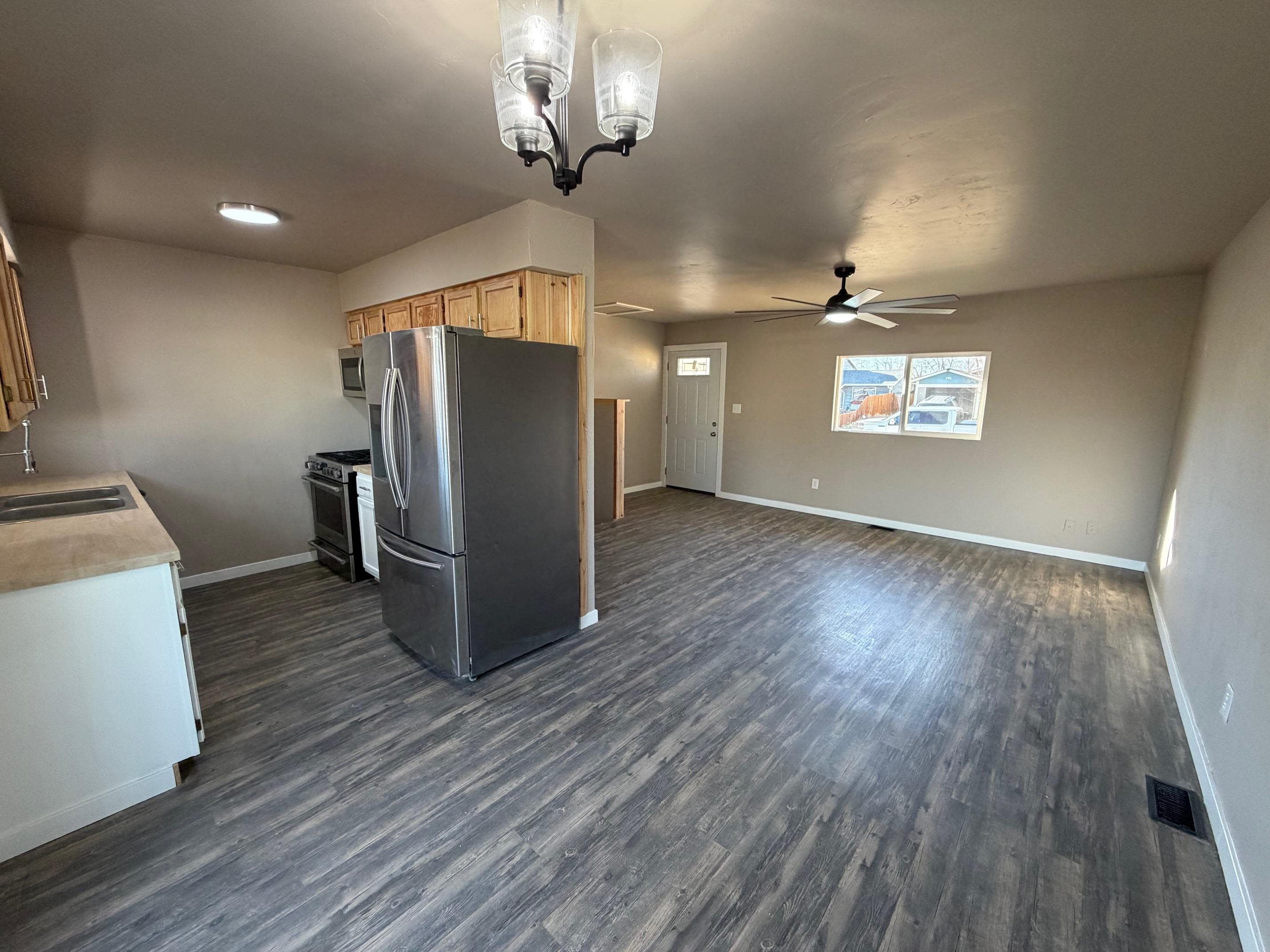 558 1/2 31 3/4 Road Grand Junction, CO 81504 - Photo 5 of 25 a view of a livingroom with wooden floor and a ceiling fan