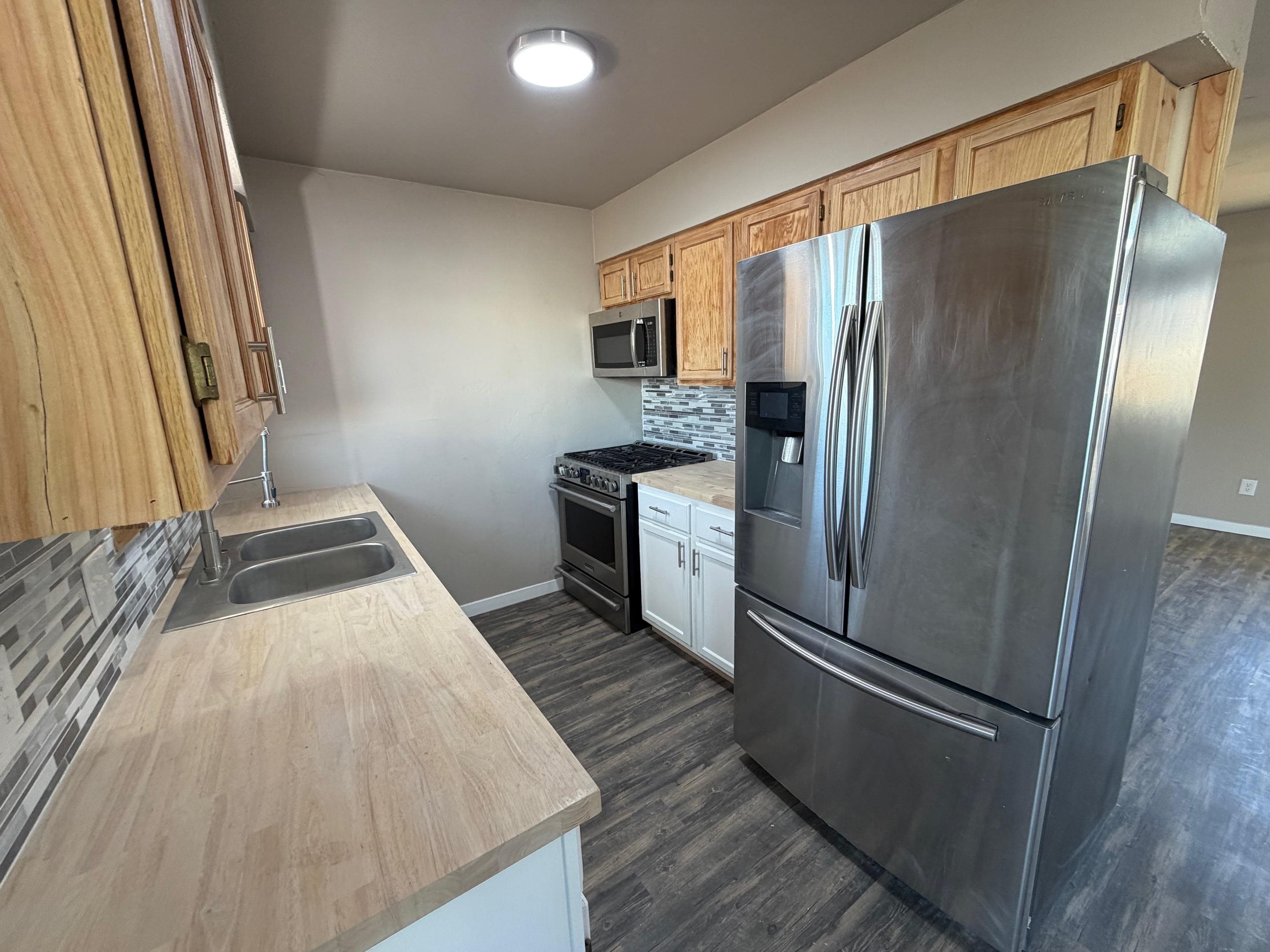 558 1/2 31 3/4 Road Grand Junction, CO 81504 - Photo 6 of 25 a kitchen with a refrigerator and a sink
