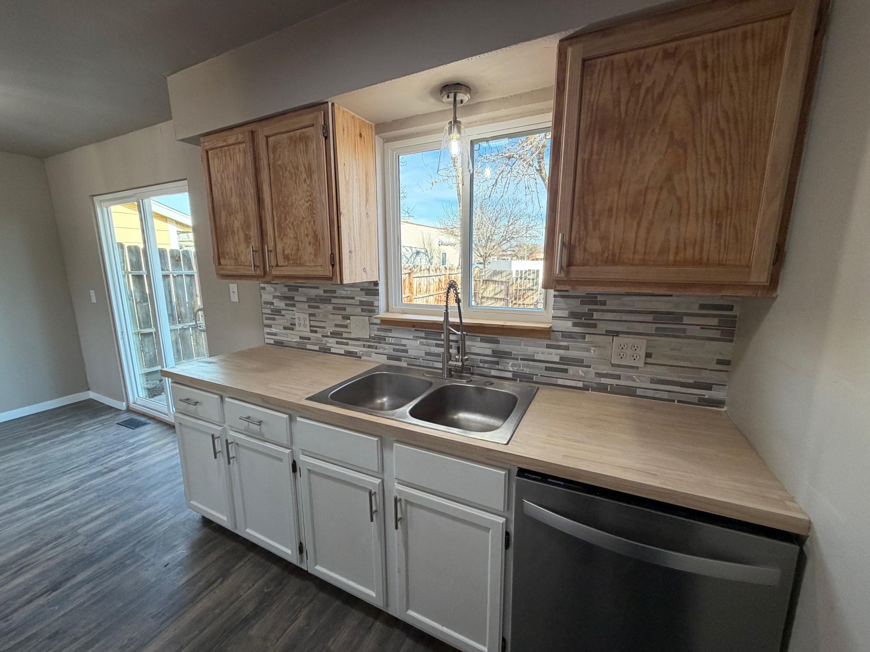 558 1/2 31 3/4 Road Grand Junction, CO 81504 - Photo 8 of 25 a kitchen with a sink and wooden cabinets