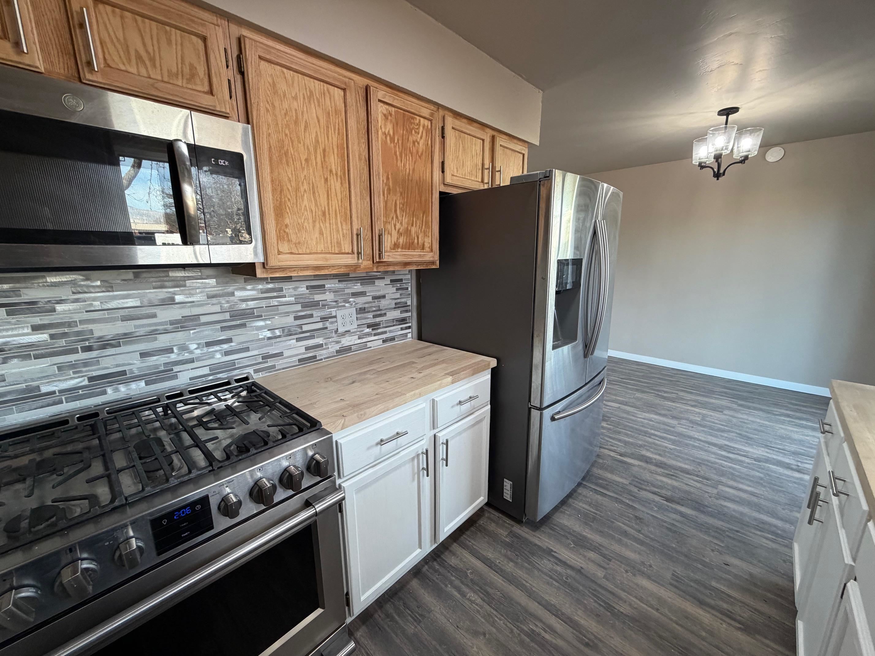558 1/2 31 3/4 Road Grand Junction, CO 81504 - Photo 9 of 25 a kitchen with stainless steel appliances granite countertop a stove microwave and refrigerator