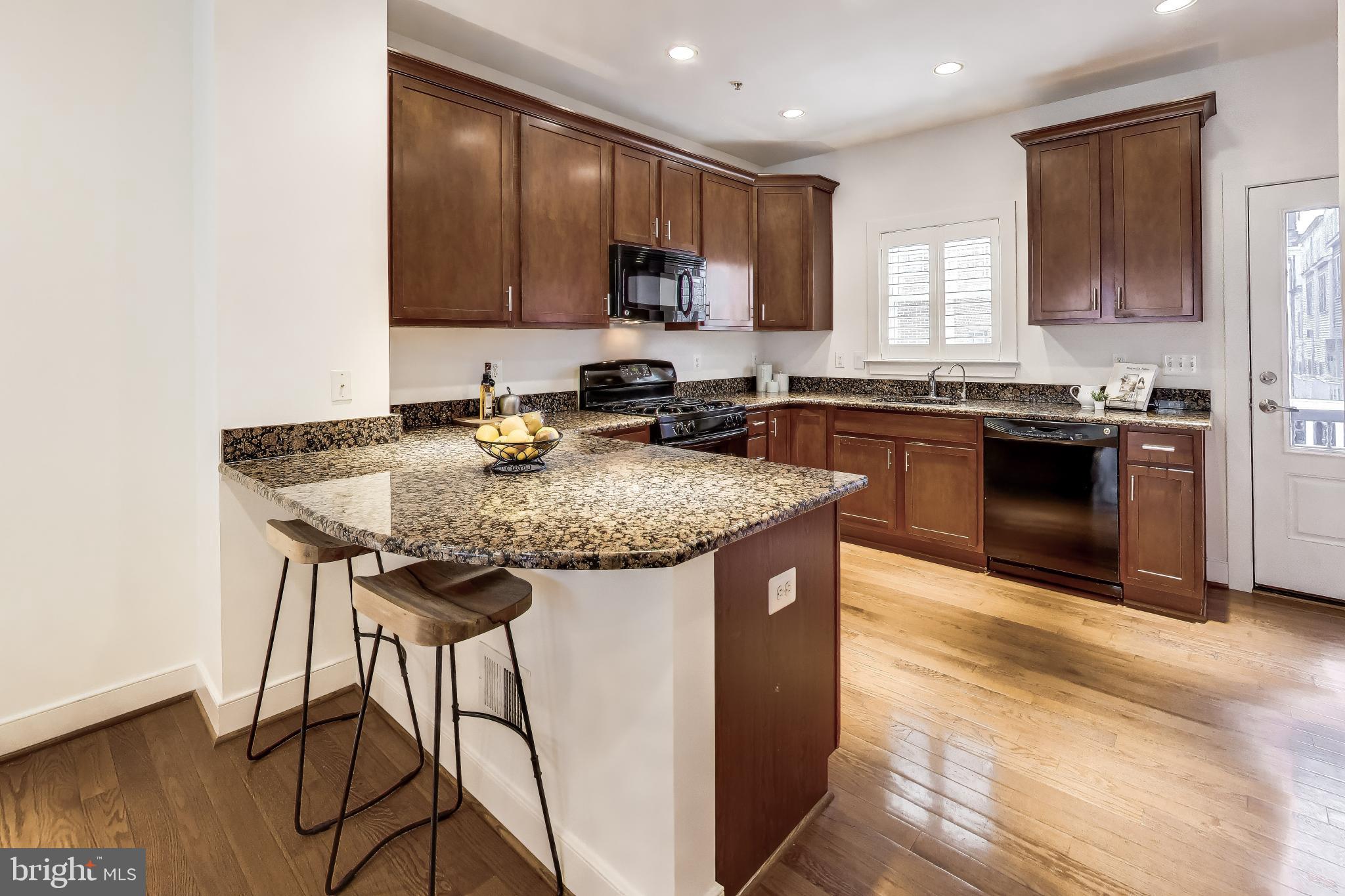 4405 Longfellow Street Hyattsville, MD 20781 - Photo 15 of 44 a kitchen with stainless steel appliances granite countertop a stove a sink a microwave a refrigerator and cabinets