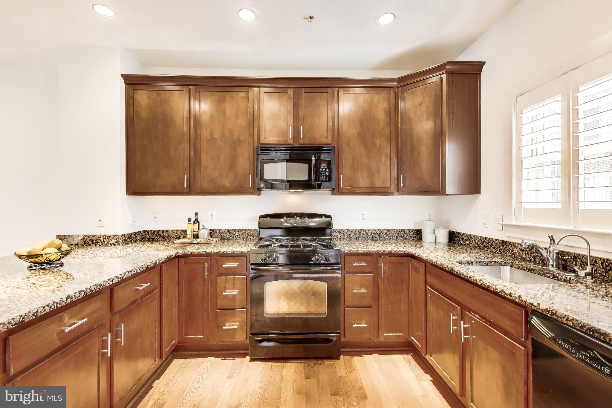 4405 Longfellow Street Hyattsville, MD 20781 - Photo 16 of 44 a kitchen with a stove a sink and a microwave