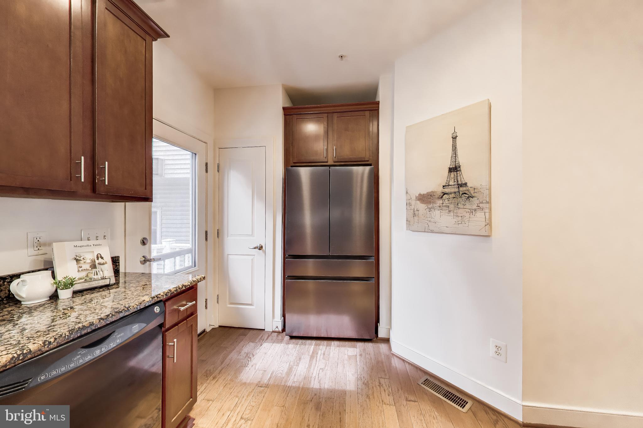 4405 Longfellow Street Hyattsville, MD 20781 - Photo 17 of 44 a kitchen with granite countertop stainless steel appliances a refrigerator a sink and wooden floor
