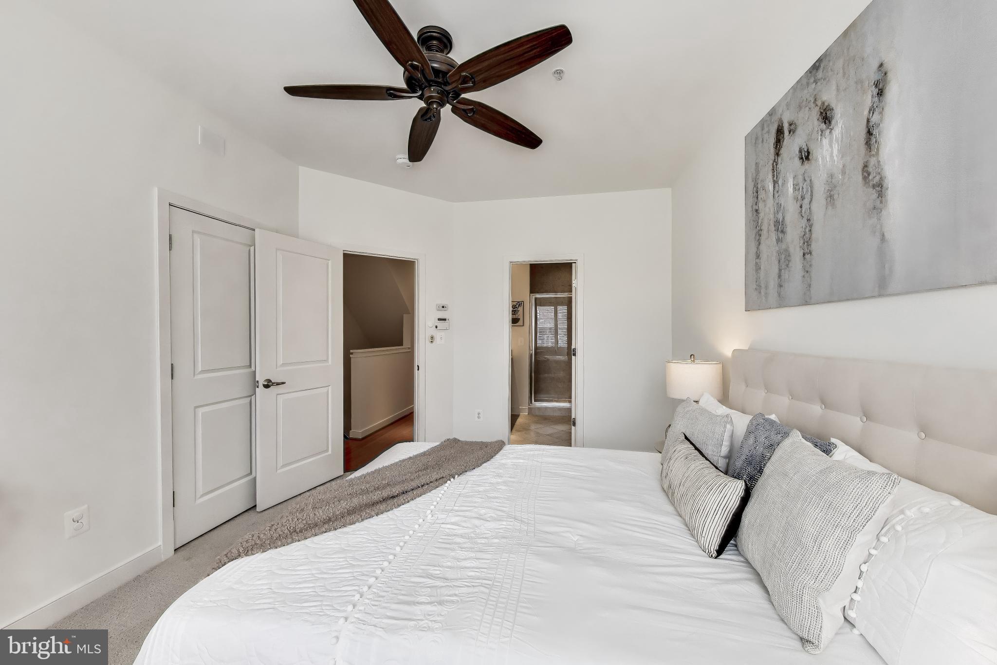 4405 Longfellow Street Hyattsville, MD 20781 - Photo 22 of 44 a bedroom with a large bed and a chandelier