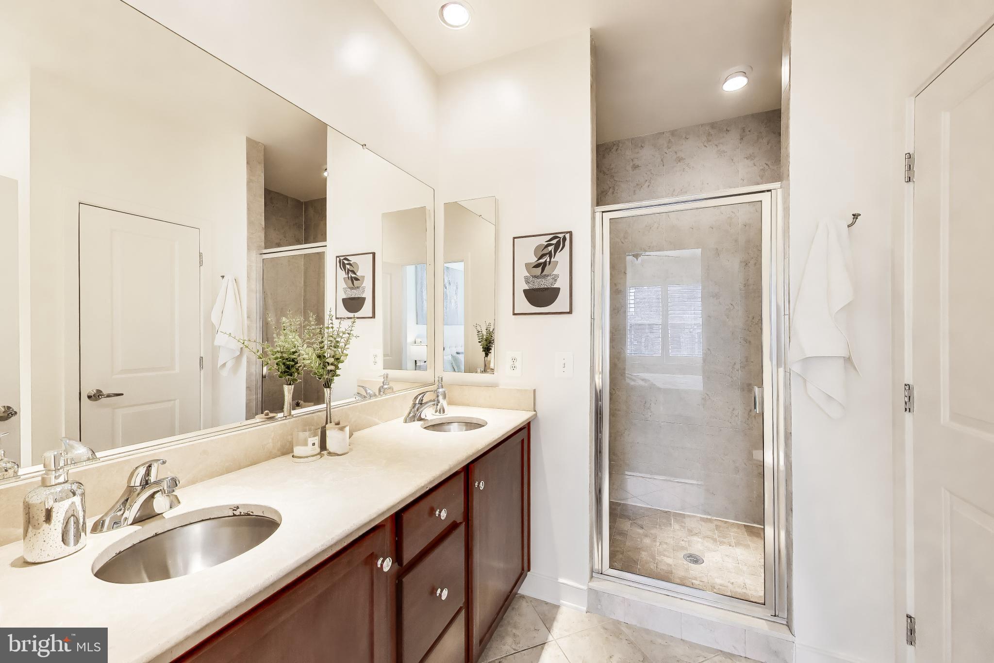 4405 Longfellow Street Hyattsville, MD 20781 - Photo 24 of 44 a bathroom with a shower sink vanity and mirror
