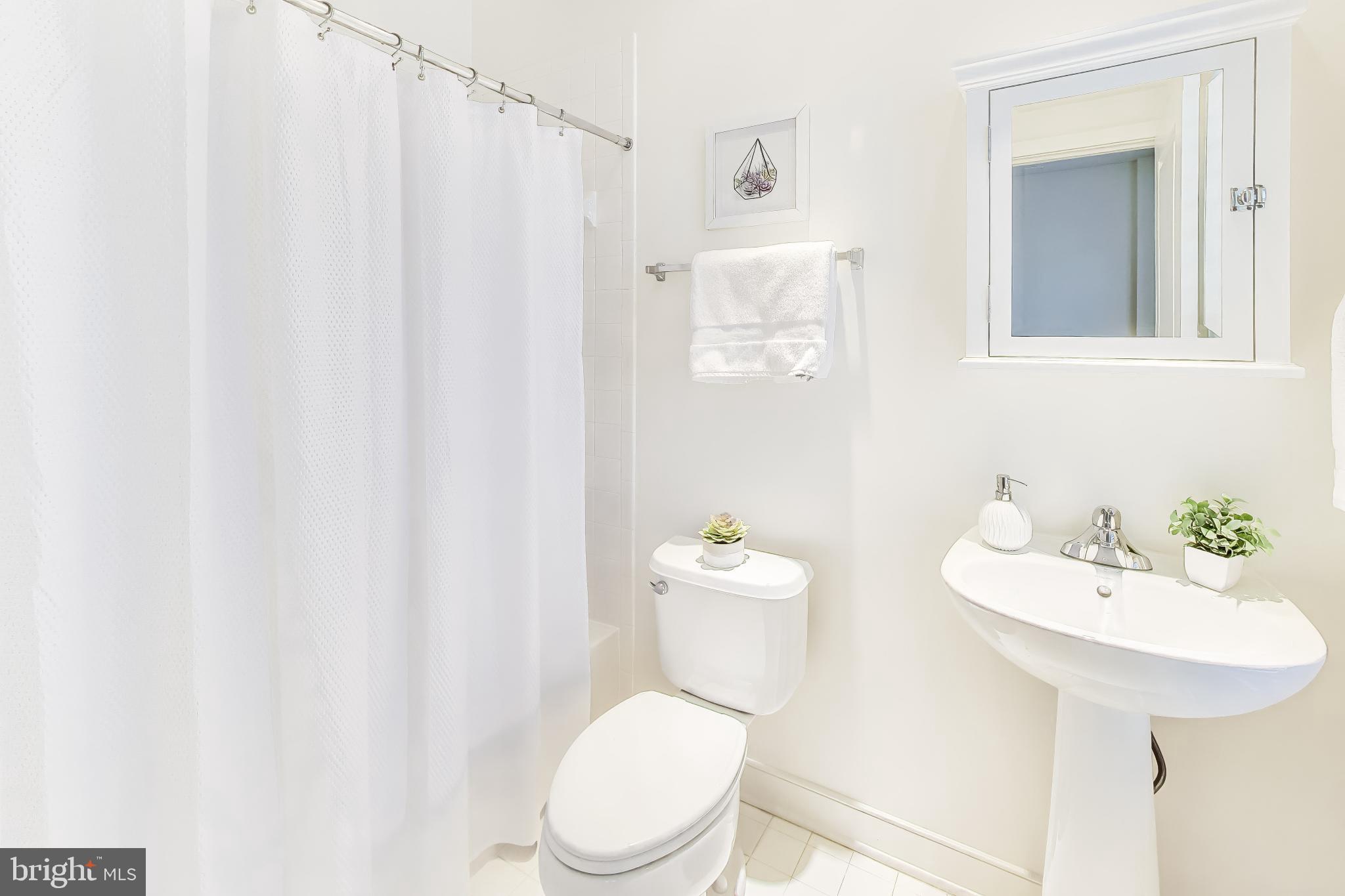 4405 Longfellow Street Hyattsville, MD 20781 - Photo 29 of 44 a white toilet sitting next to a bathroom sink