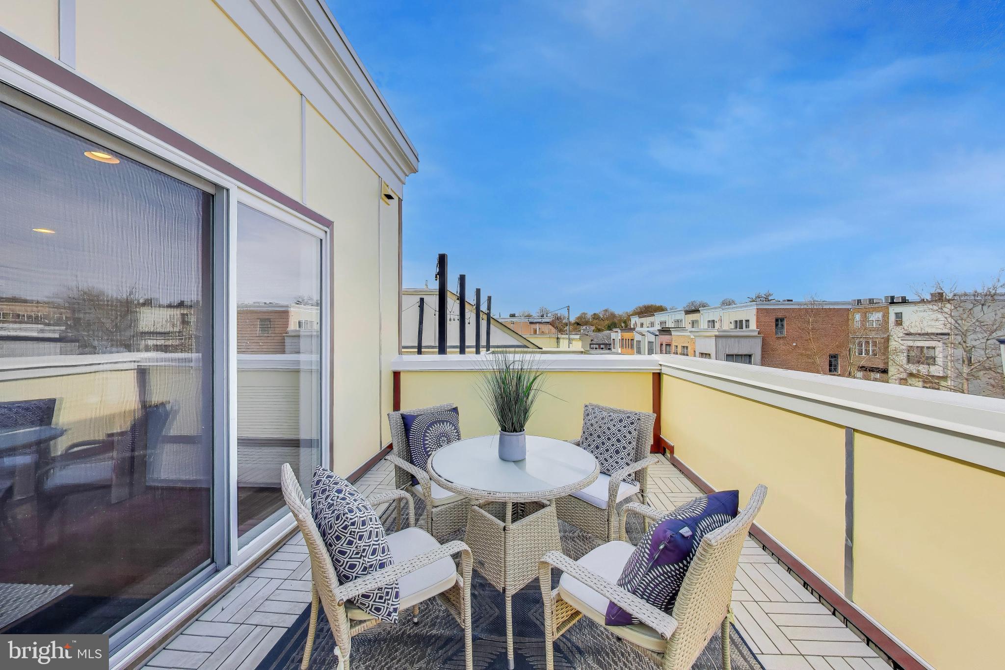 4405 Longfellow Street Hyattsville, MD 20781 - Photo 39 of 44 a view of a balcony dining area with a table and chairs