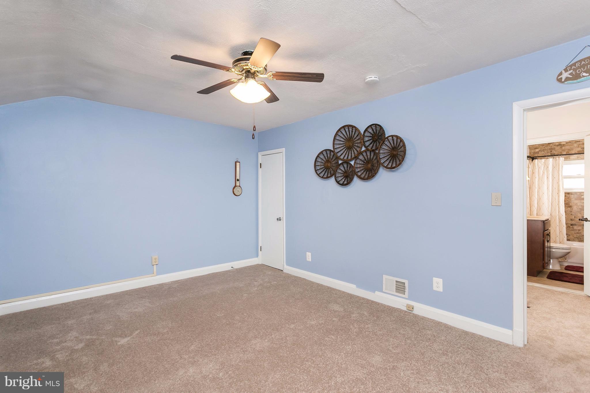 708 Arncliffe Road Baltimore, MD 21221 - Photo 14 of 30 a view of a livingroom with a ceiling fan and window