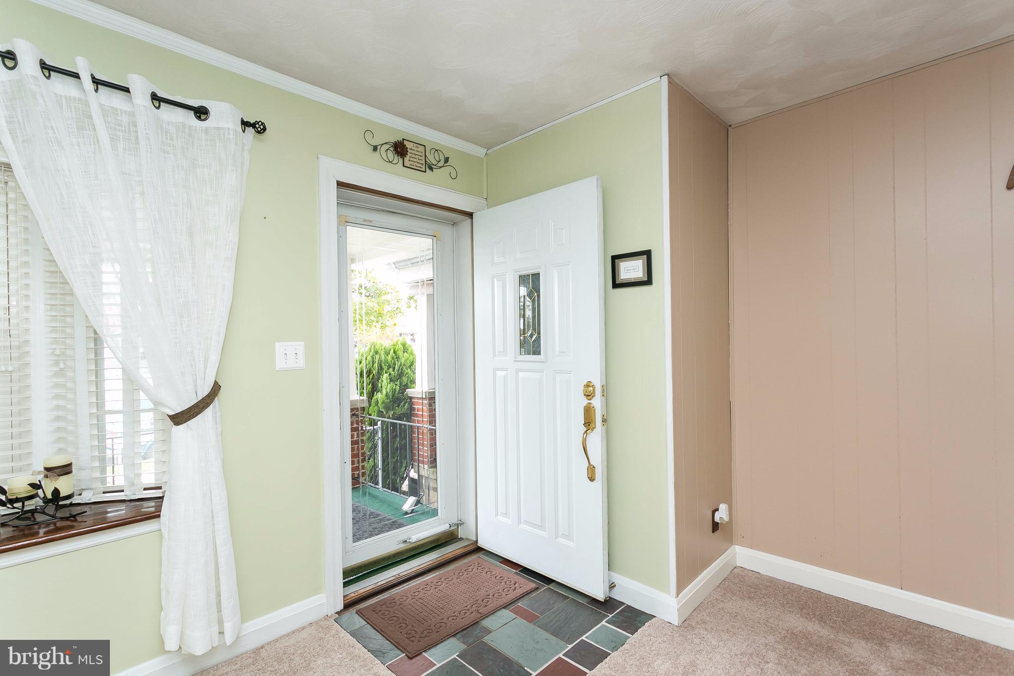 708 Arncliffe Road Baltimore, MD 21221 - Photo 3 of 30 a view of a bathroom with a shower and a window