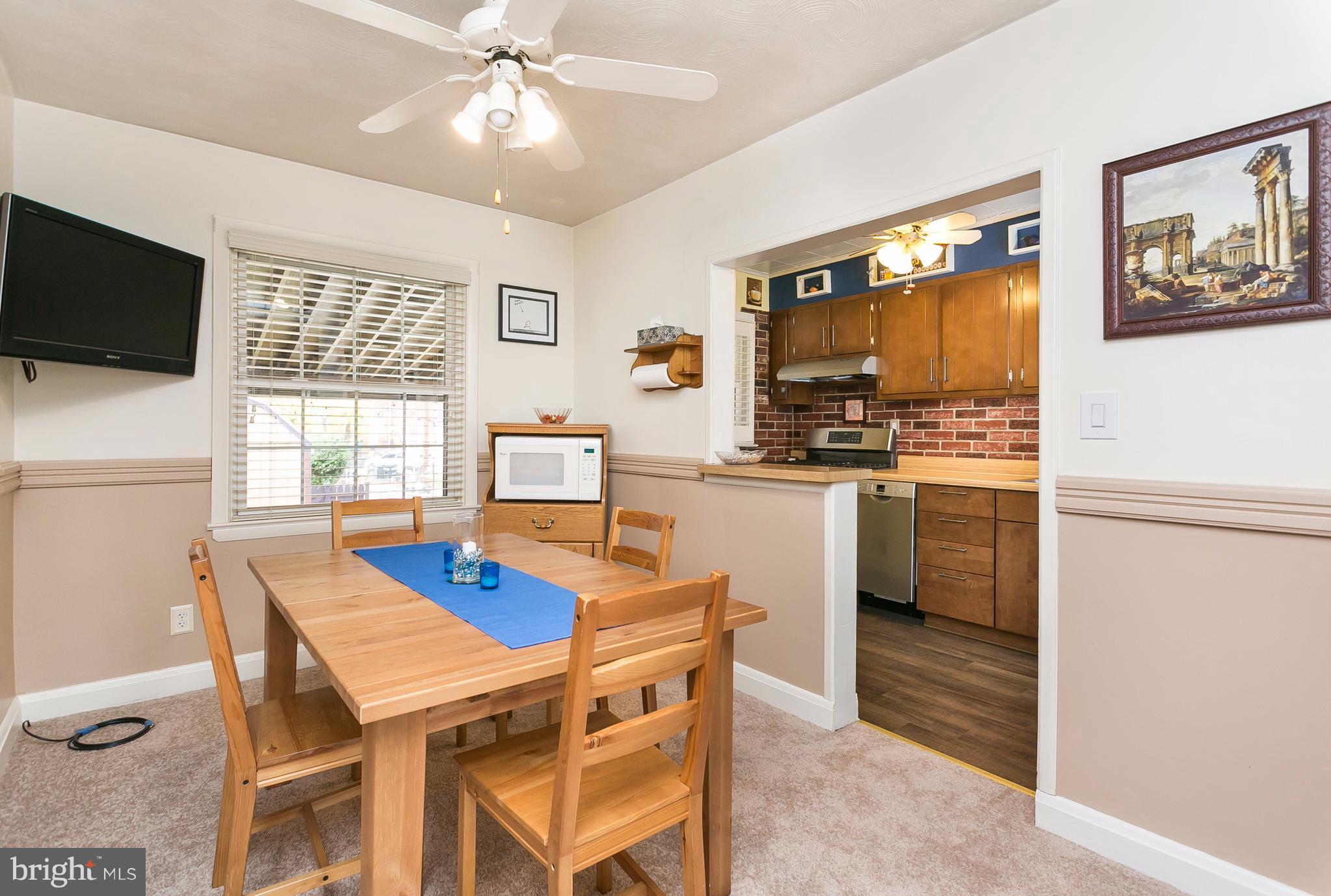 708 Arncliffe Road Baltimore, MD 21221 - Photo 8 of 30 a dining room with furniture a window and kitchen view