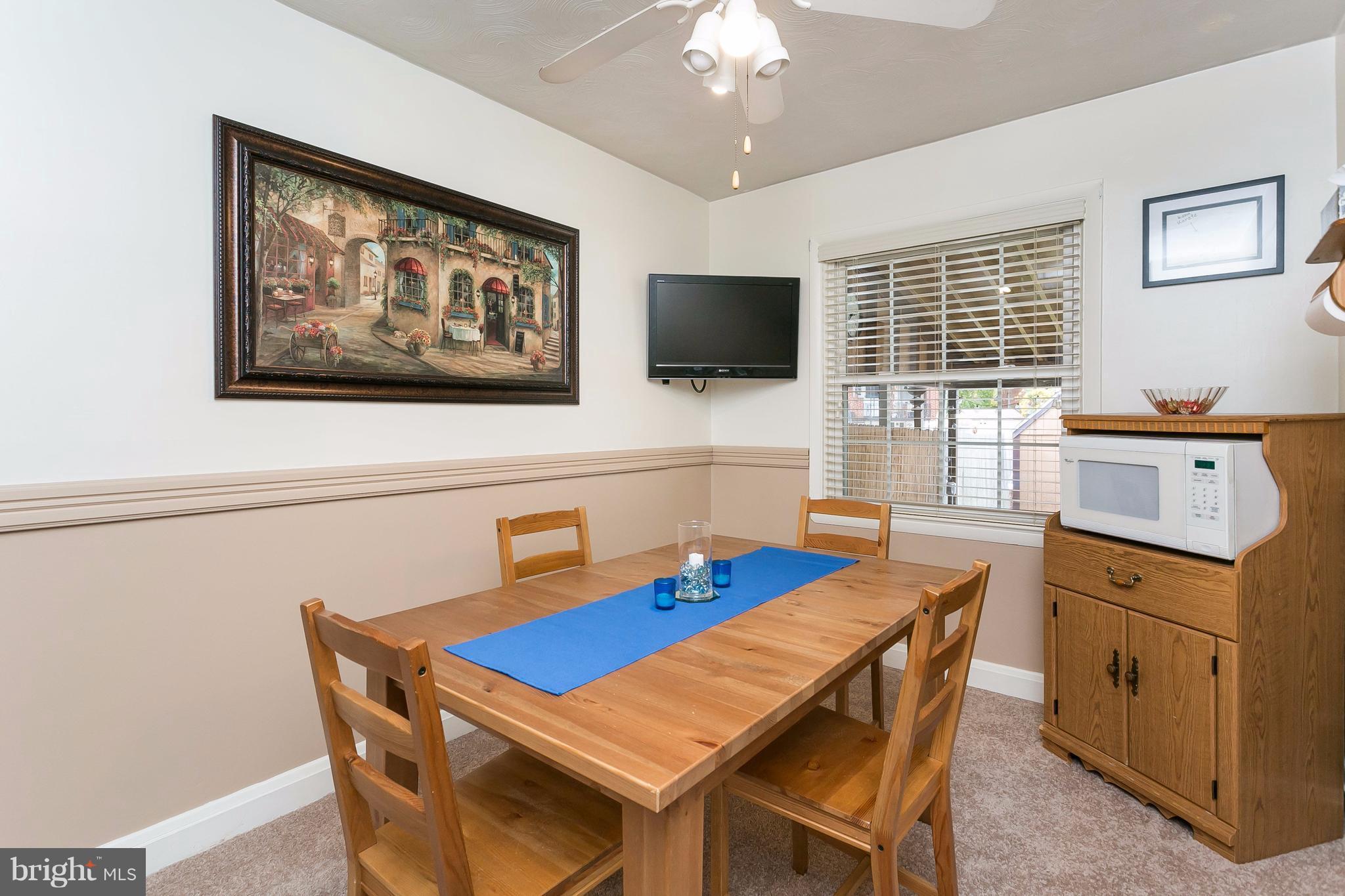708 Arncliffe Road Baltimore, MD 21221 - Photo 9 of 30 a view of a dining room with furniture window and wooden floor