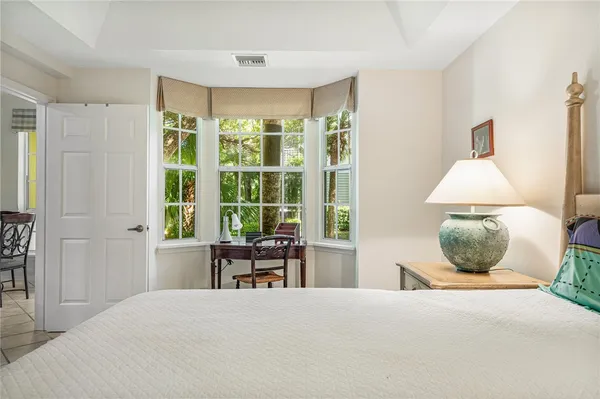 a bedroom with a large bed and a window