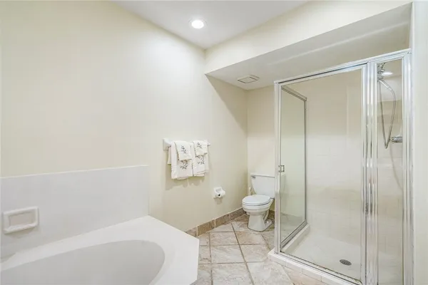 a bathroom with a toilet and a shower