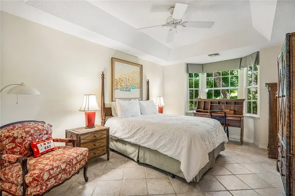 a bedroom with a bed and large window