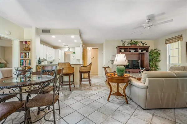 a living room with furniture a fireplace and a chandelier