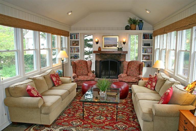 45 Gibson Road Orleans, MA 02653 - Photo 12 of 33 a living room with furniture a fireplace and a floor to ceiling window