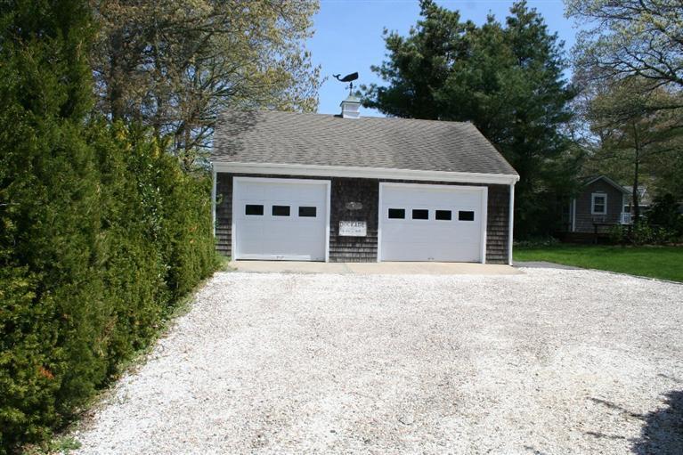 45 Gibson Road Orleans, MA 02653 - Photo 14 of 33 front view of a house with a yard and garage