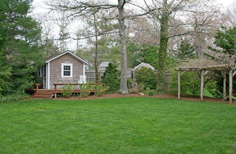 45 Gibson Road Orleans, MA 02653 - Photo 15 of 33 a front view of a house with a garden and trees