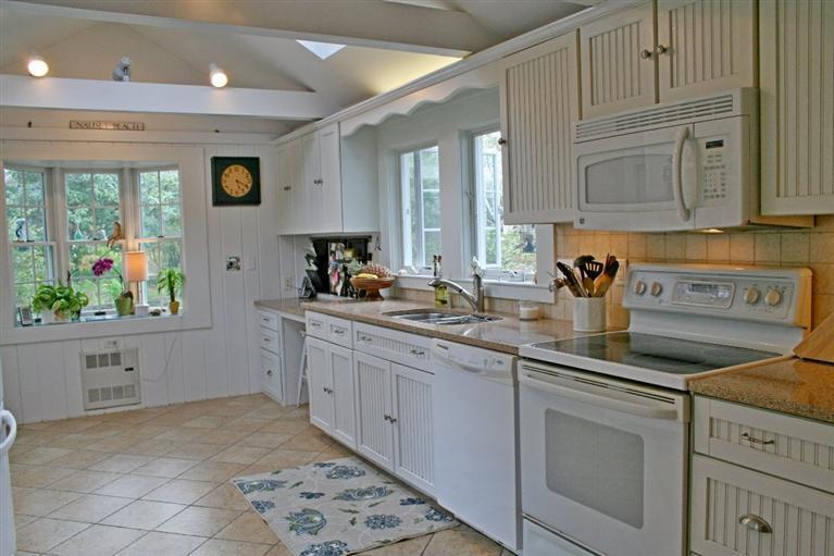 45 Gibson Road Orleans, MA 02653 - Photo 22 of 33 a kitchen with stainless steel appliances granite countertop a sink a stove and cabinets
