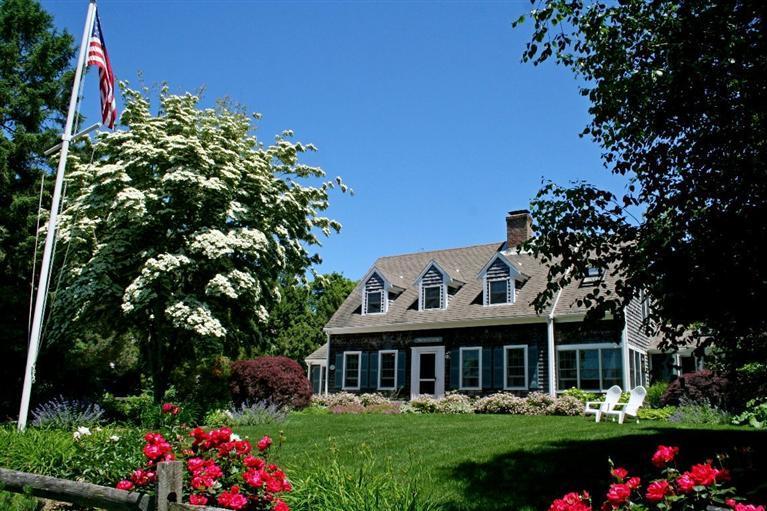45 Gibson Road Orleans, MA 02653 - Photo 31 of 33 a front view of a house with a yard and potted plants