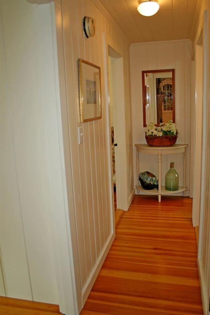 45 Gibson Road Orleans, MA 02653 - Photo 5 of 33 a view of a hallway with wooden floor and a bathroom