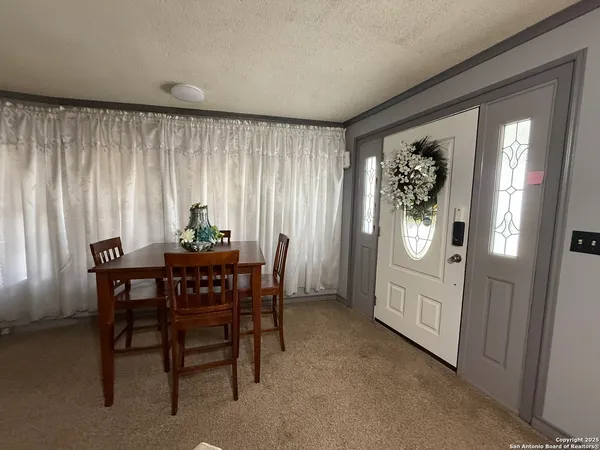 a view of a dining room with furniture and window