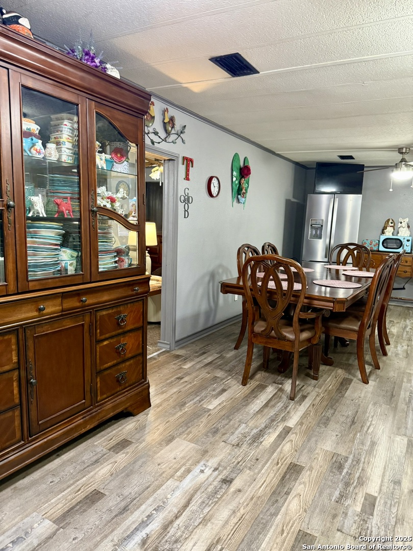 508 East Thornton Street Three Rivers, TX 78071 - Photo 8 of 17 a view of a dining room with furniture window and wooden floor