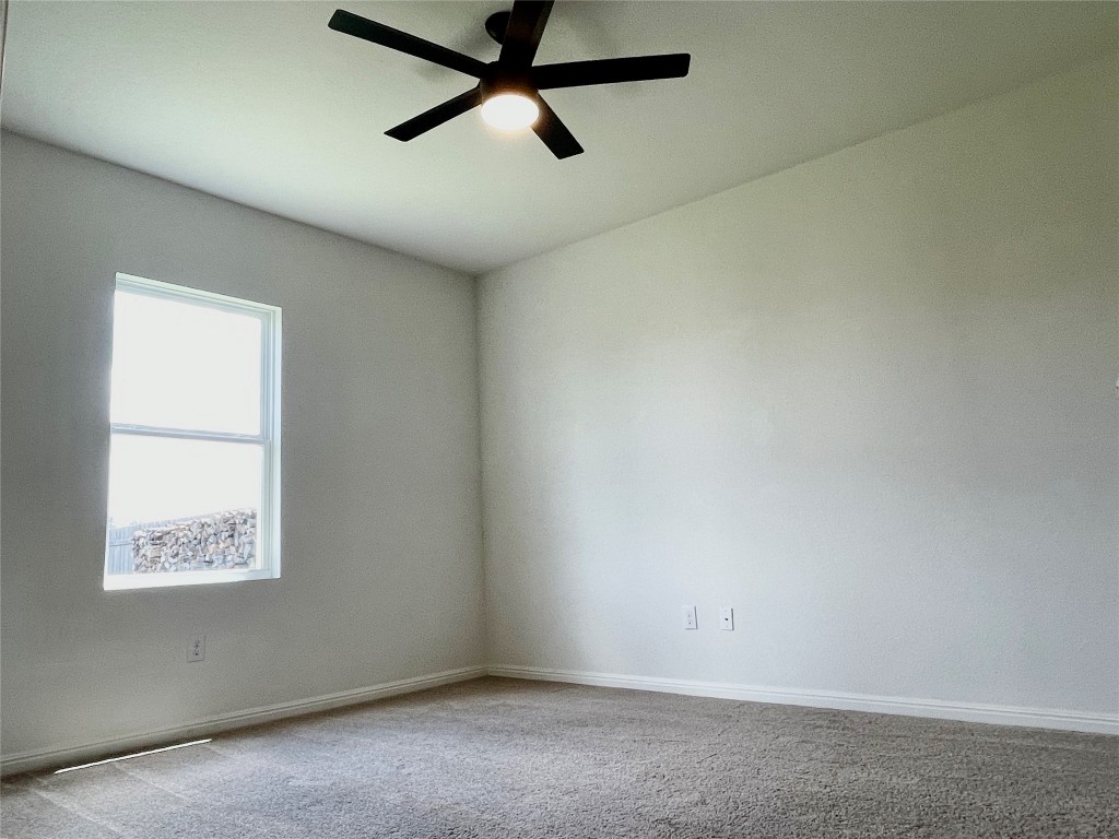 532 Peony Court Jarrell, TX 76537 - Photo 9 of 19 an empty room with a window and a ceiling fan