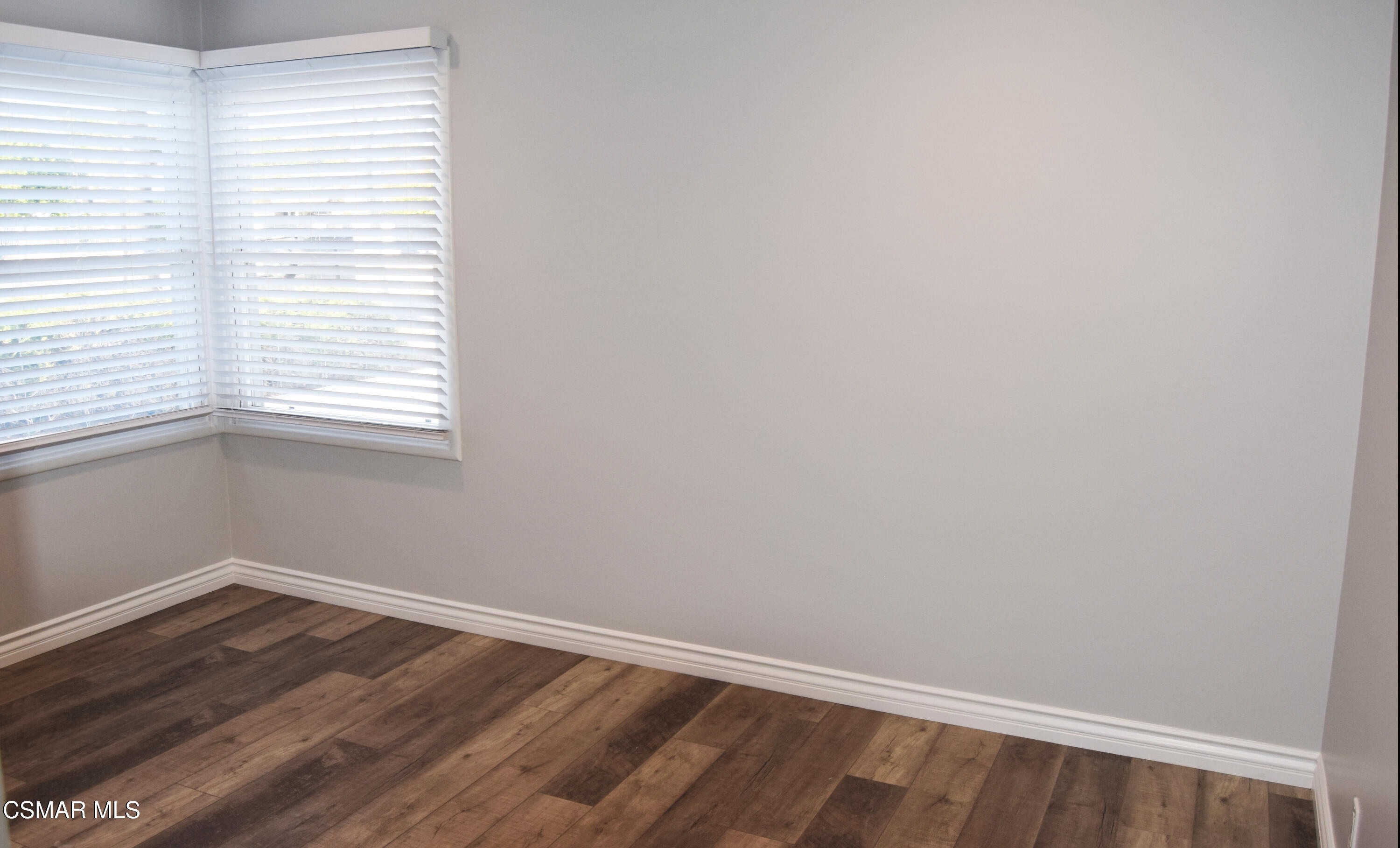 9131 Bartee Avenue Arleta, CA 91331 - Photo 17 of 27 an empty room with wooden floor and windows