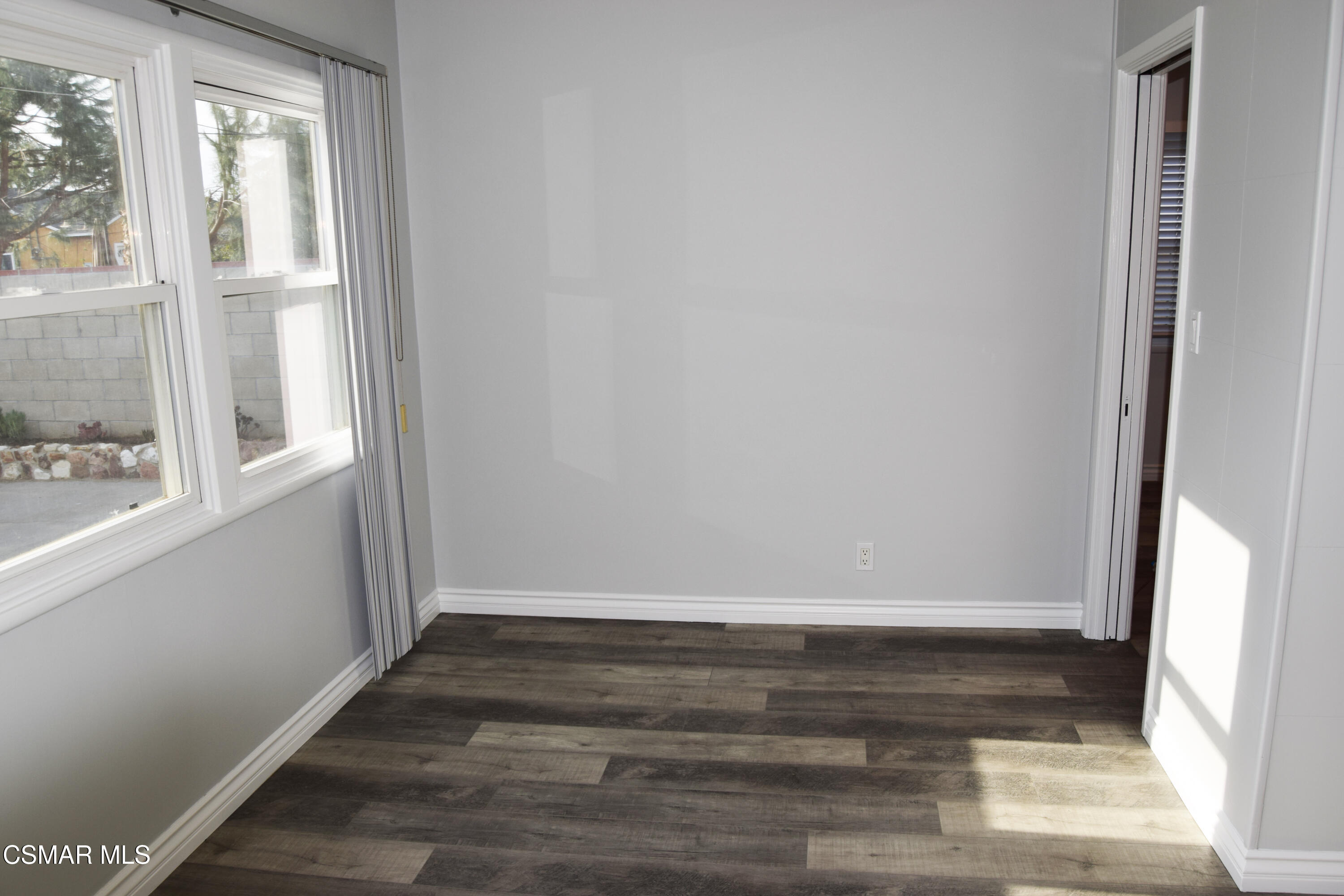 9131 Bartee Avenue Arleta, CA 91331 - Photo 6 of 27 an empty room with wooden floor and windows