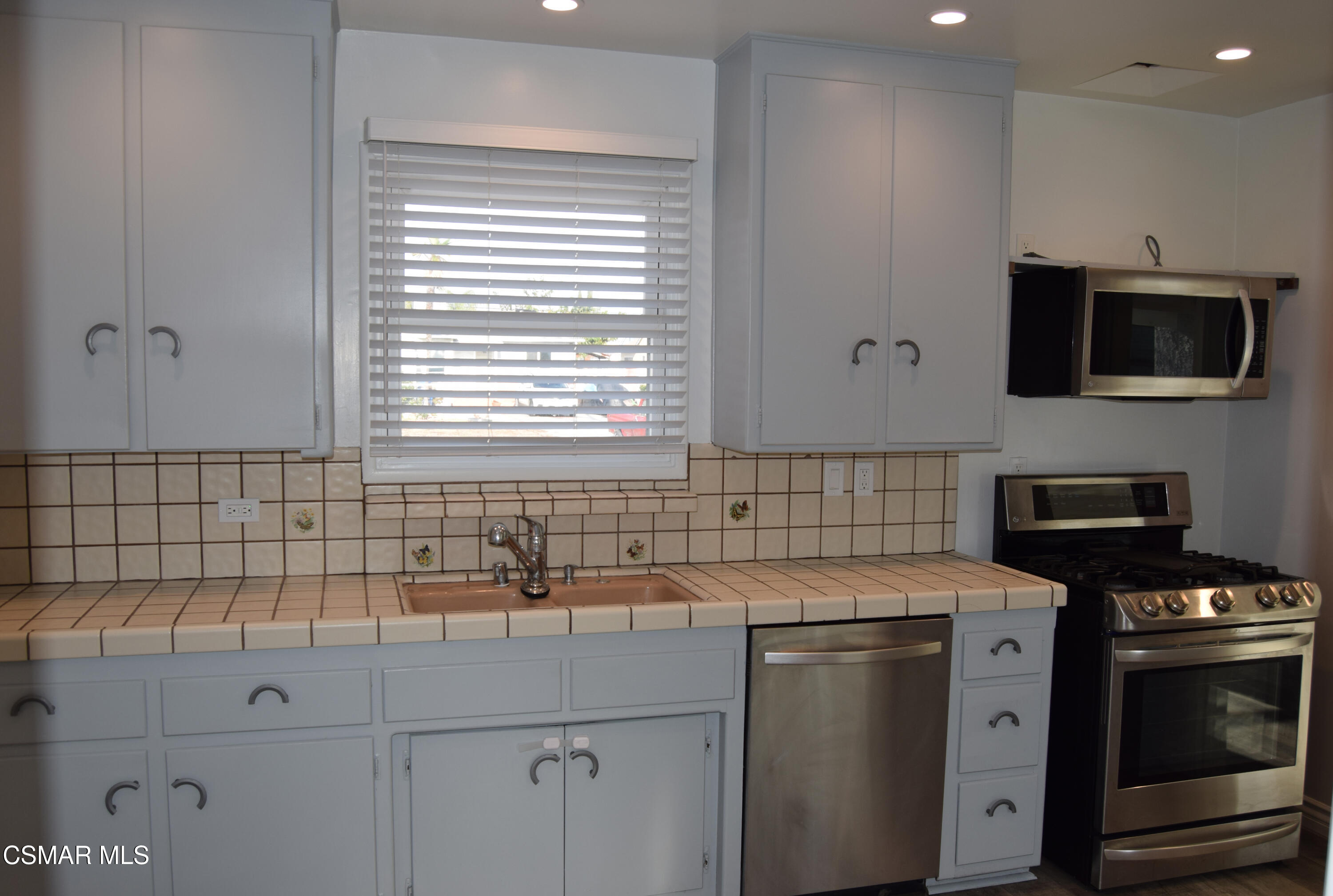 9131 Bartee Avenue Arleta, CA 91331 - Photo 9 of 27 a kitchen with a sink and a stove top oven