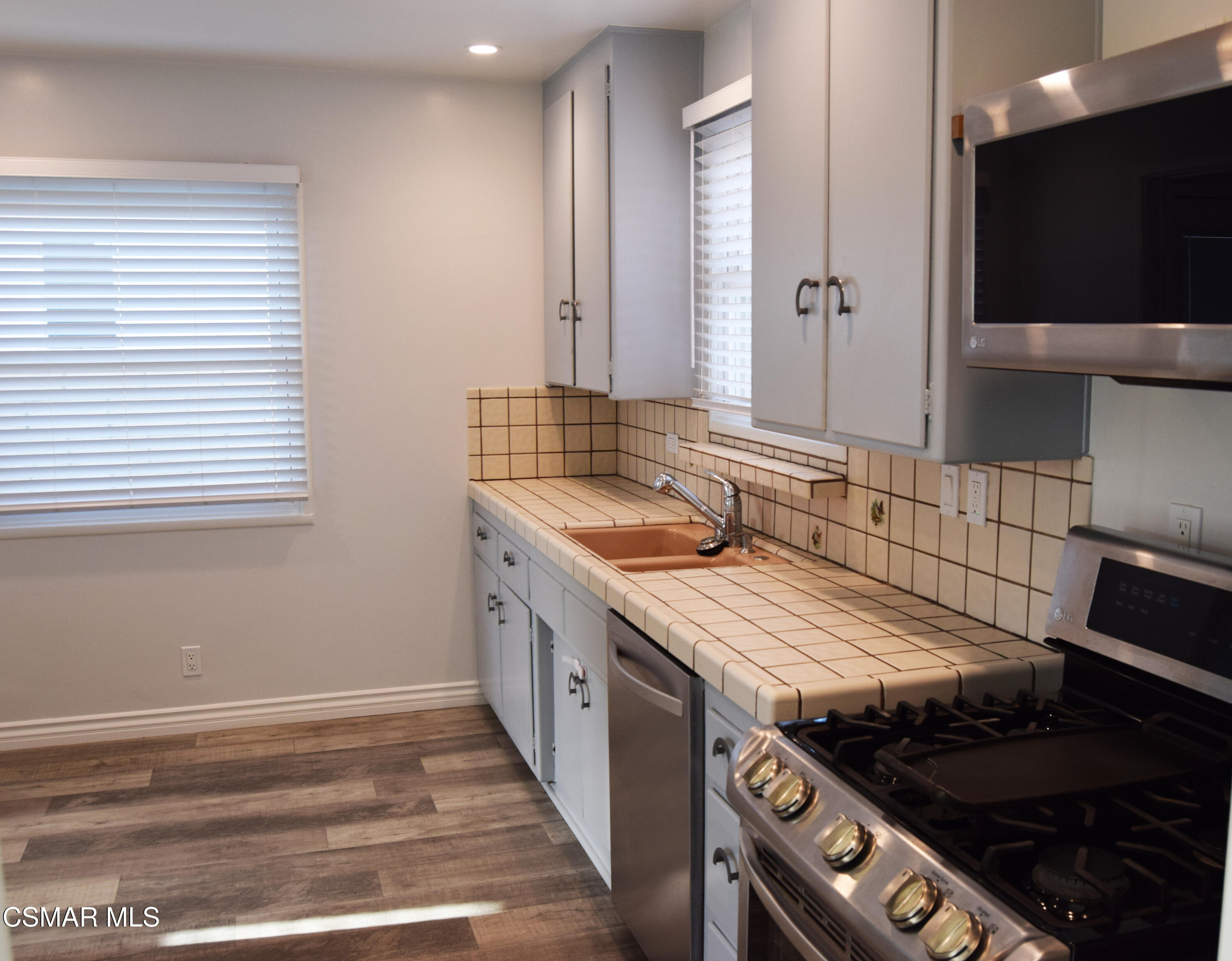 9131 Bartee Avenue Arleta, CA 91331 - Photo 10 of 27 a kitchen with a stove and a wooden floor