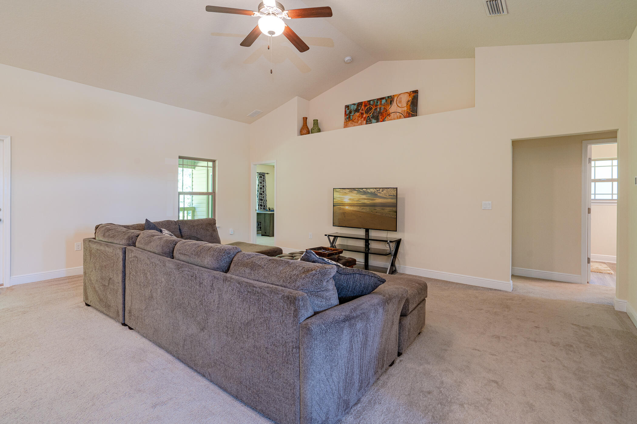 6028 Hidden Valley Road Crestview, FL 32539 - Photo 11 of 45 a living room with furniture and a flat screen tv