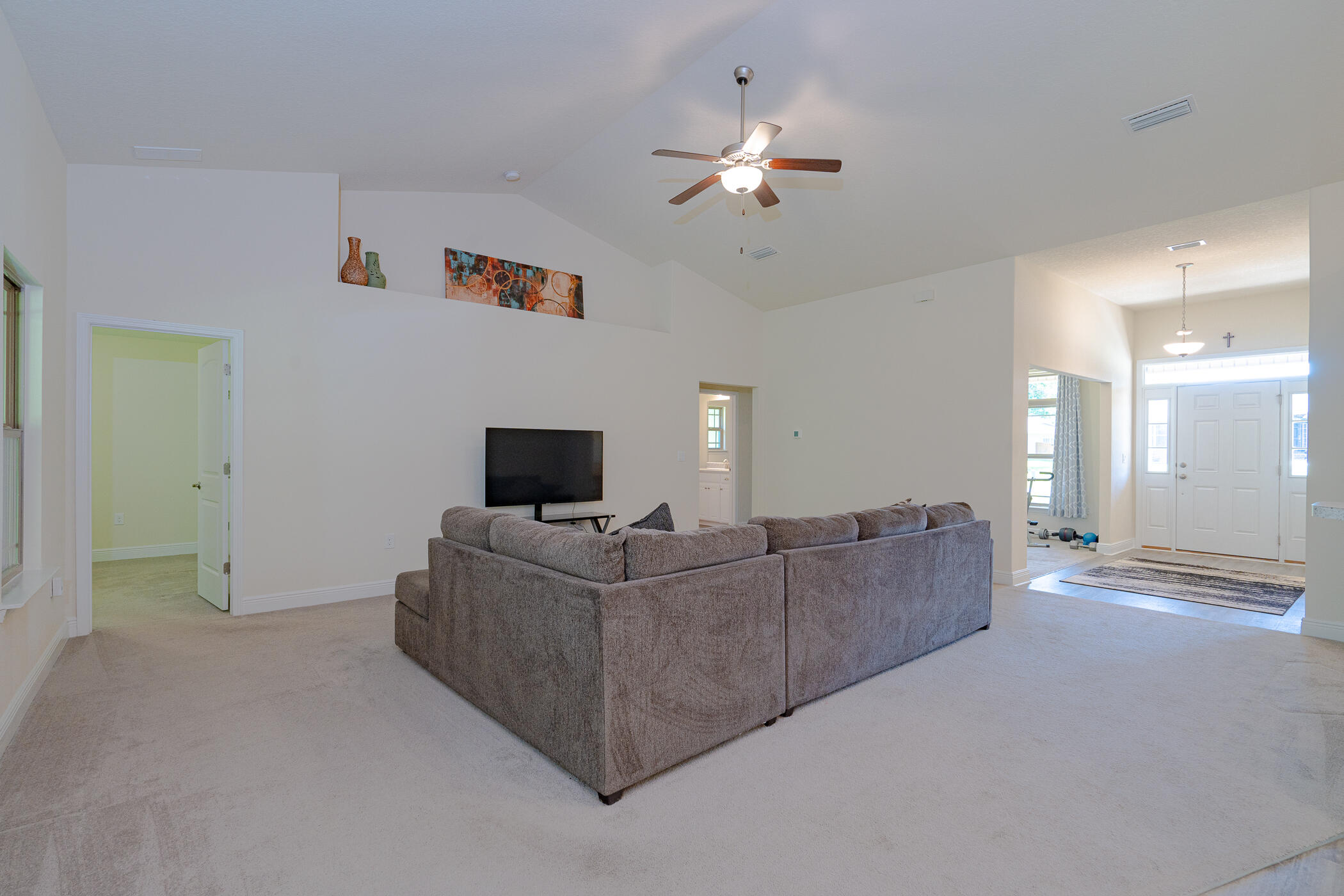 6028 Hidden Valley Road Crestview, FL 32539 - Photo 12 of 45 a living room with furniture and a flat screen tv