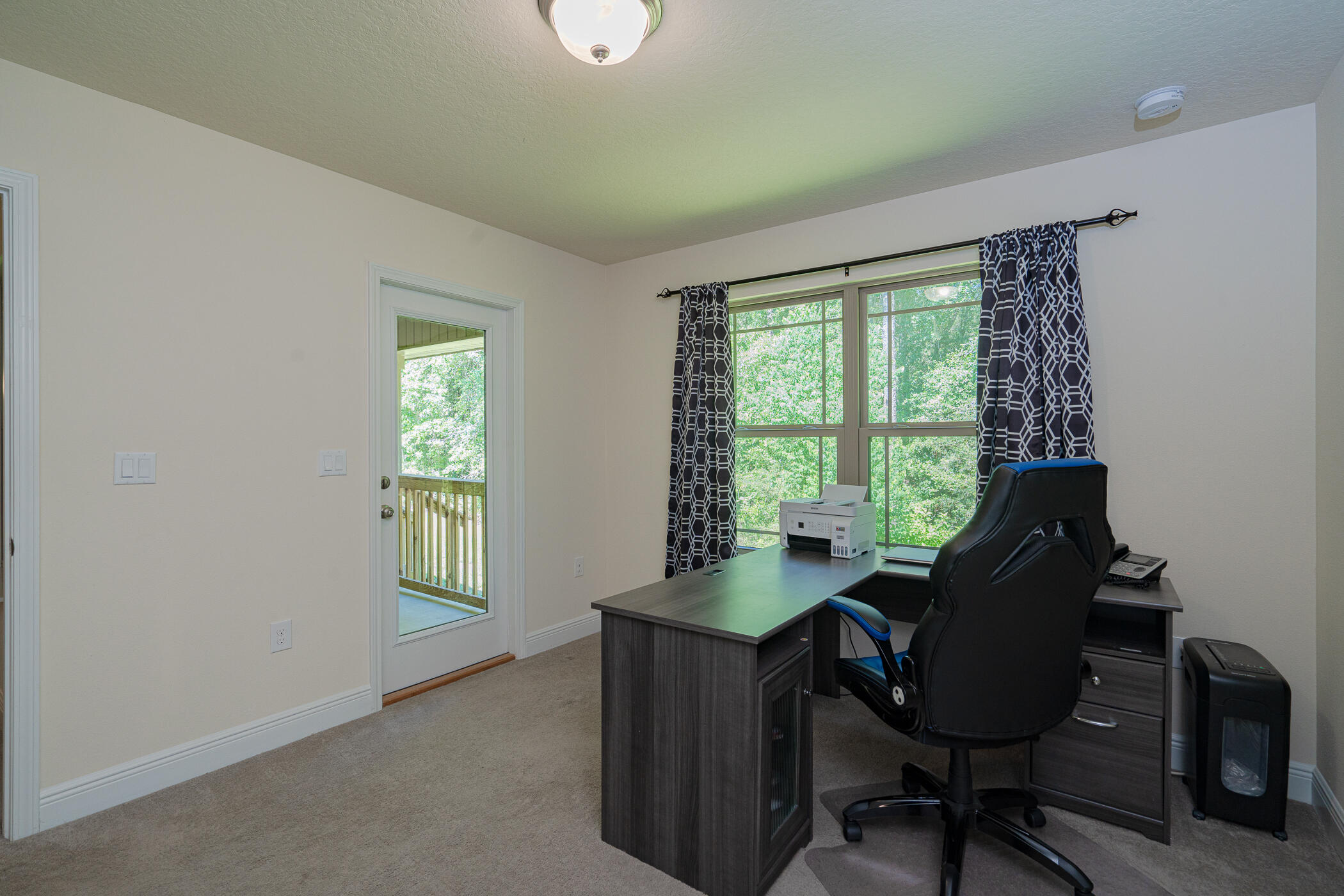 6028 Hidden Valley Road Crestview, FL 32539 - Photo 31 of 45 a view of a workspace with furniture and a window