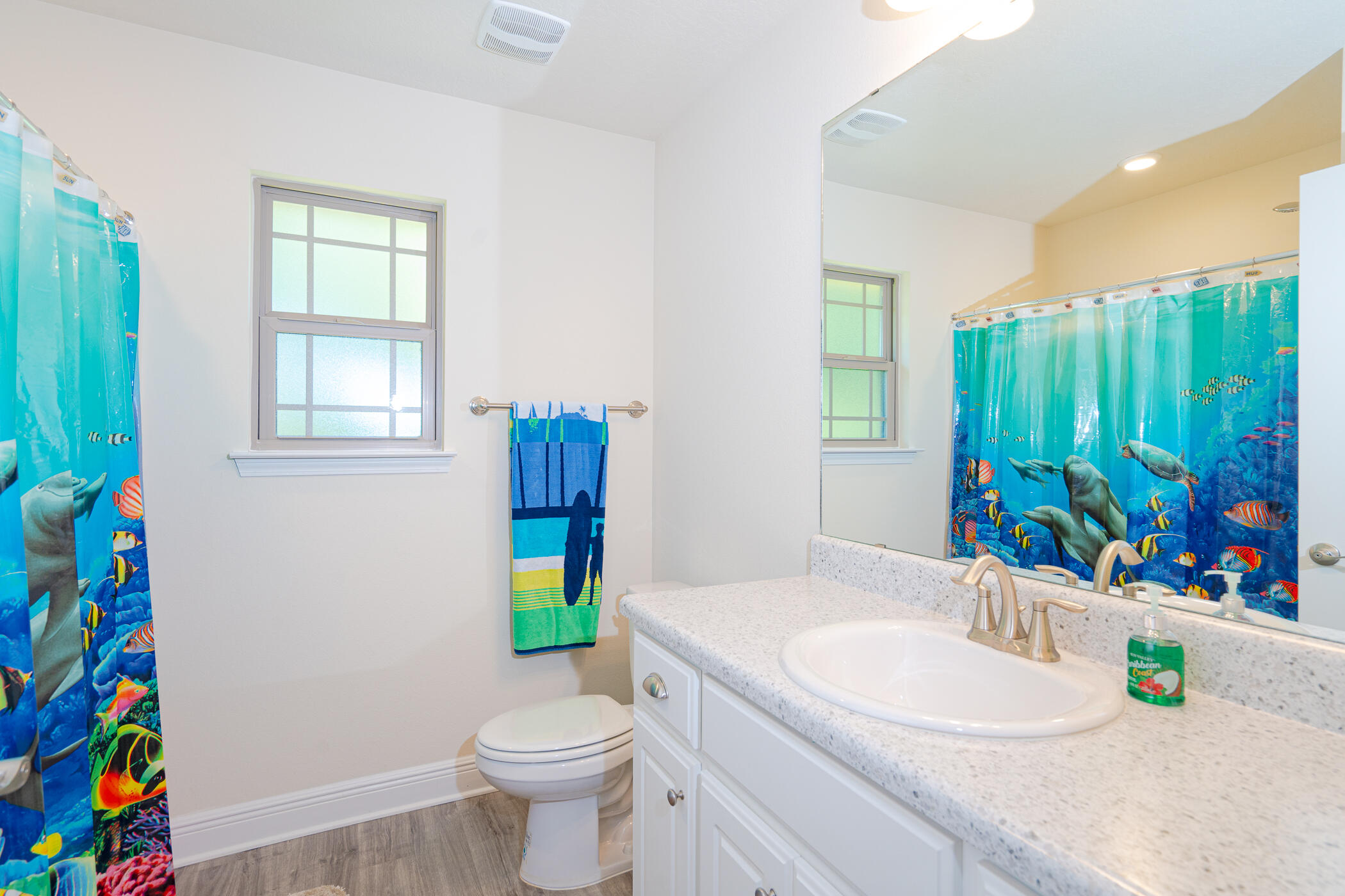 6028 Hidden Valley Road Crestview, FL 32539 - Photo 36 of 45 a bathroom with a sink a toilet and a window