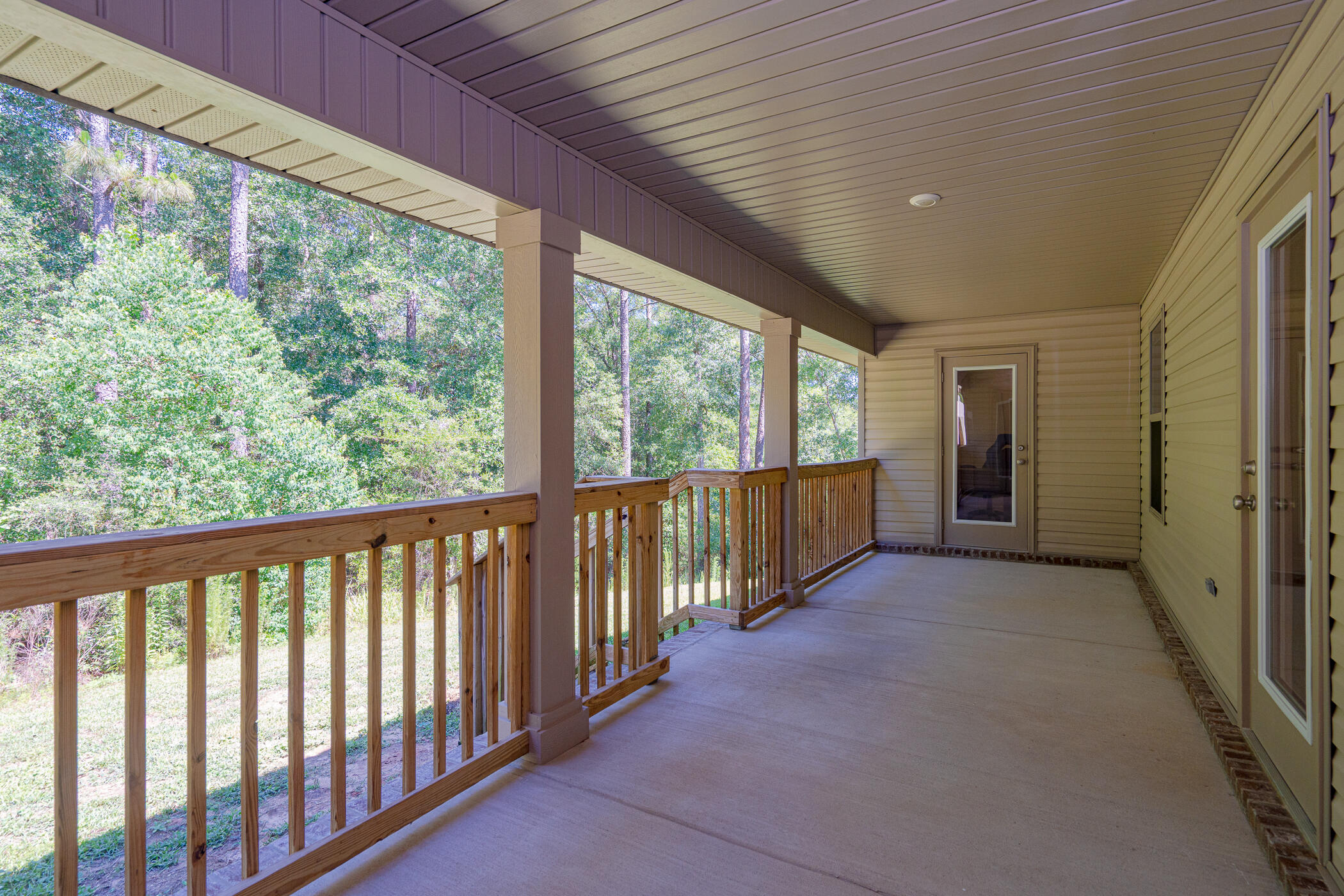 6028 Hidden Valley Road Crestview, FL 32539 - Photo 42 of 45 a view of a porch with wooden floor and outdoor space