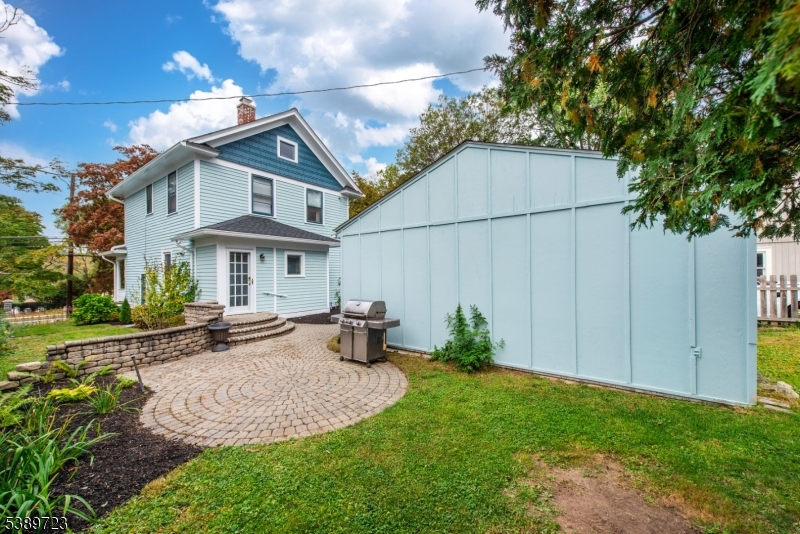 41 Anderson Hill Road Bernardsville, NJ 07924 - Photo 15 of 15 a view of a white house with a chairs and table in a yard