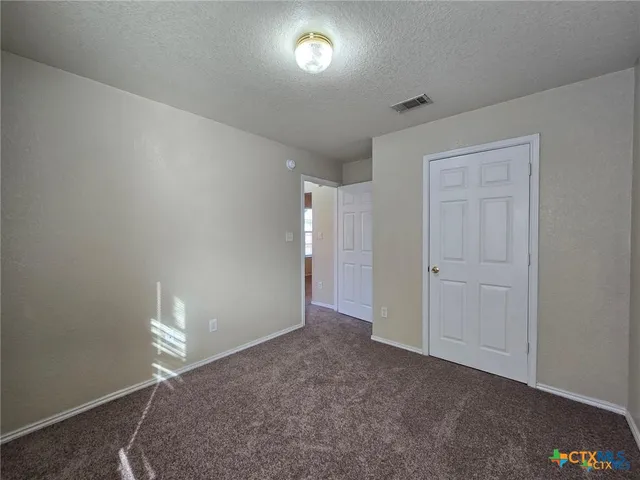 a view of an empty room and a window