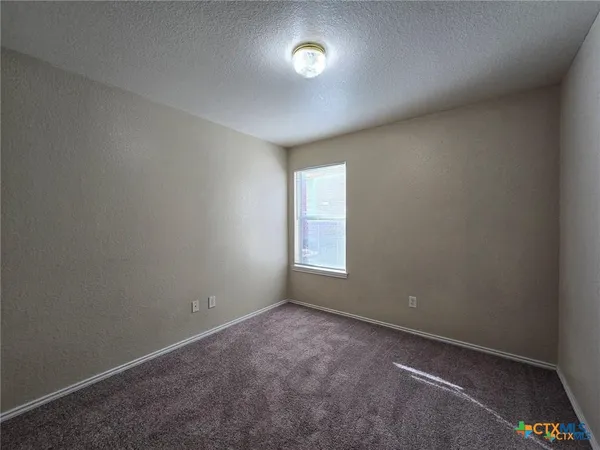 an empty room with a empty space and windows