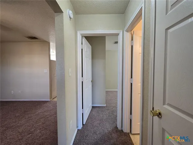 a view of a bathroom from a hallway