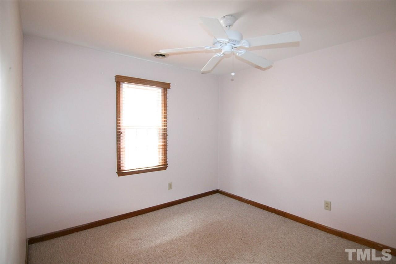 4612 Draper Road Raleigh, NC 27616 - Photo 11 of 16 an empty room with windows and fan