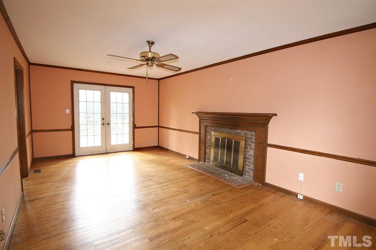 4612 Draper Road Raleigh, NC 27616 - Photo 3 of 16 a view of a livingroom with wooden floor and a ceiling fan