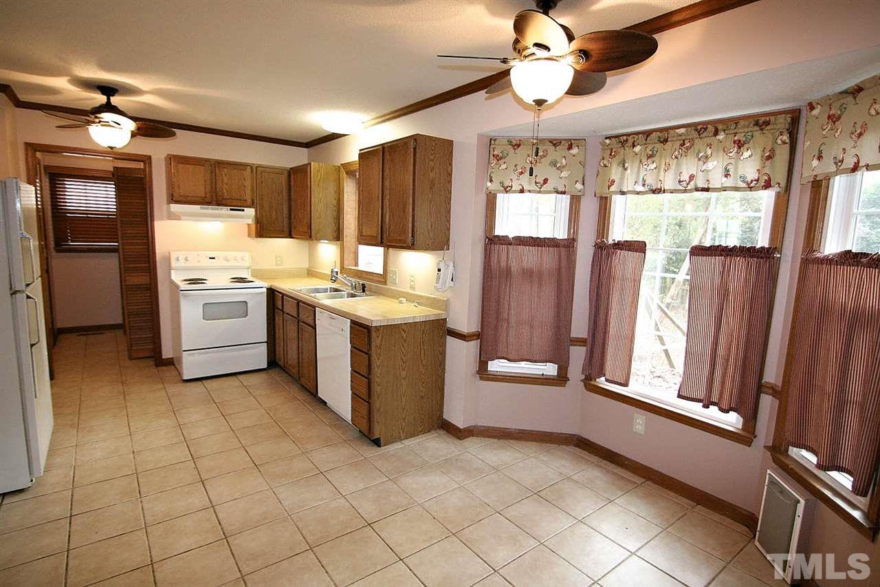 4612 Draper Road Raleigh, NC 27616 - Photo 6 of 16 a kitchen with refrigerator and window