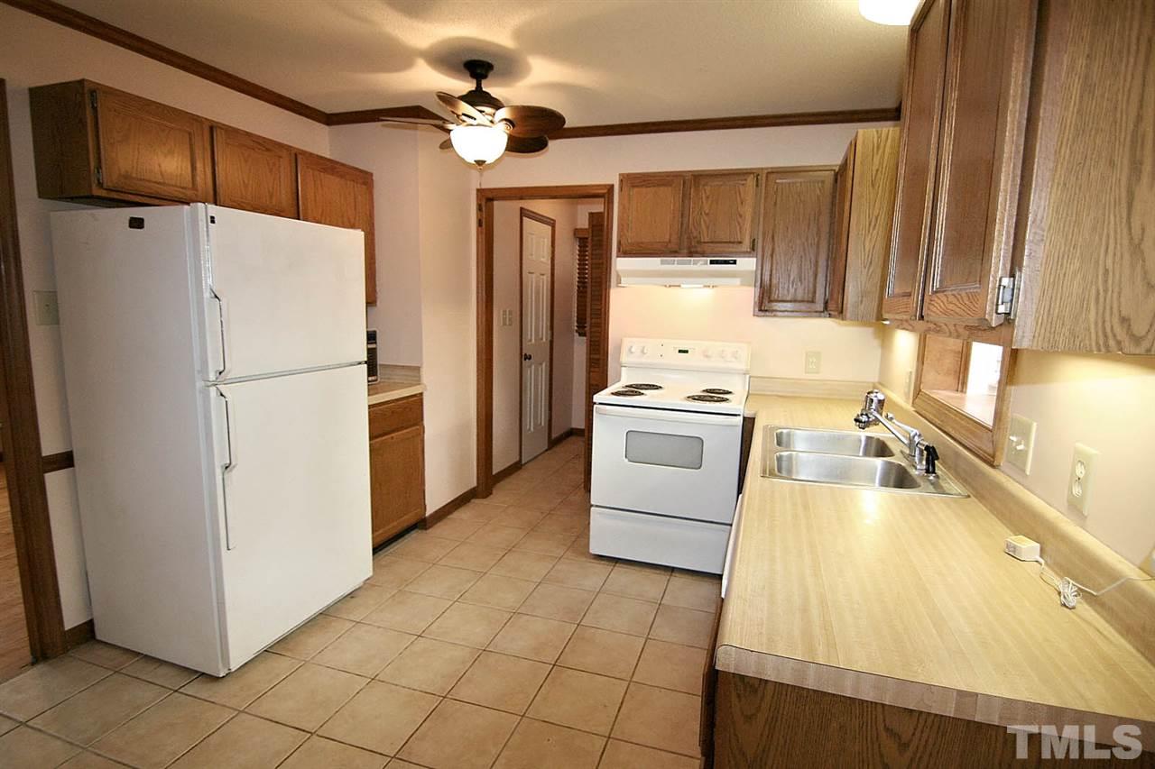 4612 Draper Road Raleigh, NC 27616 - Photo 7 of 16 a kitchen with a refrigerator a stove top oven a sink and dishwasher