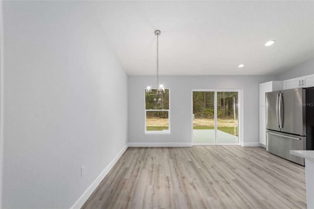 6832 Southwest 153rd Pl Road Ocala, FL 34473 - Photo 11 of 31 a view of an empty room with a window and wooden floor