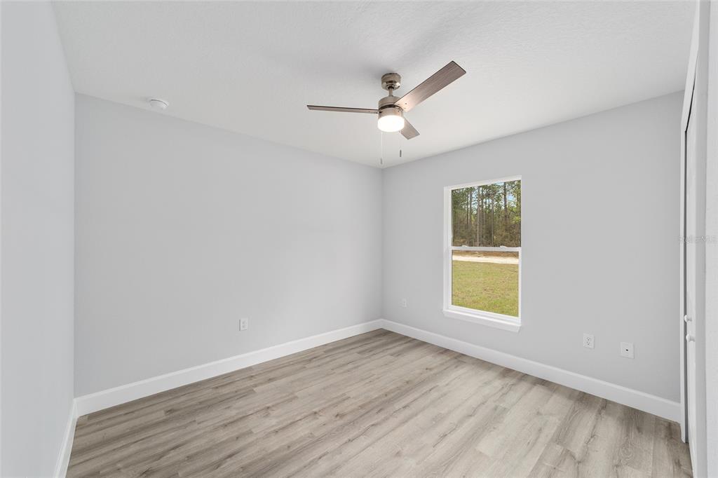 6832 Southwest 153rd Pl Road Ocala, FL 34473 - Photo 25 of 31 an empty room with a window and a ceiling fan