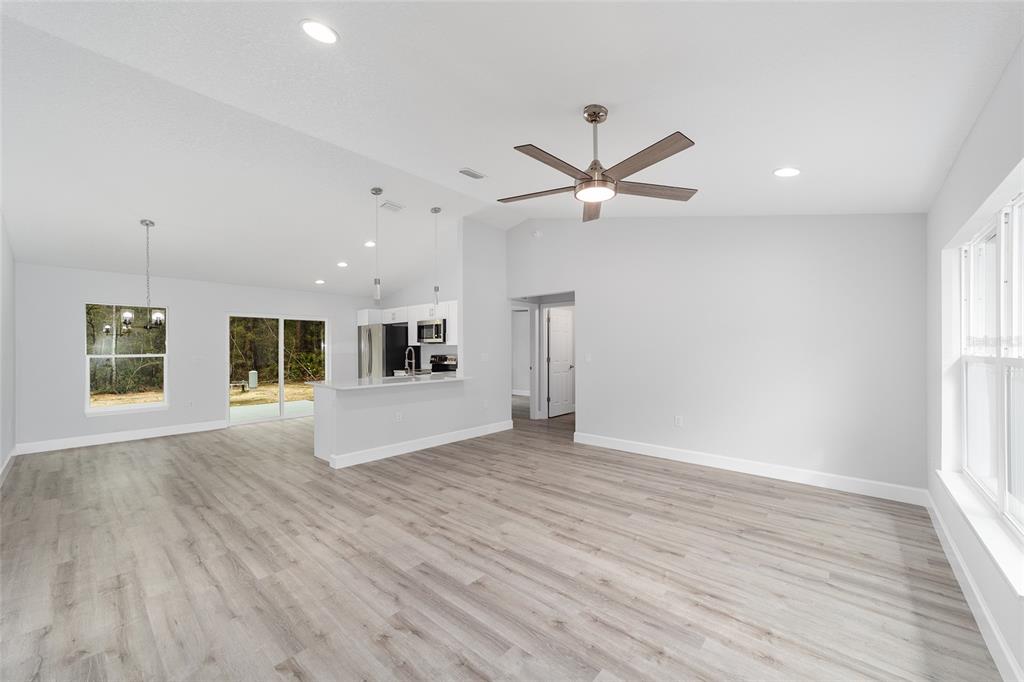 6832 Southwest 153rd Pl Road Ocala, FL 34473 - Photo 7 of 31 an empty room with wooden floor and windows